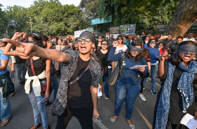 : Women wearing blindfolds raise slogans in solidarity with rape victims during a protest to highlight the issue of violence against women in the country,  in New Delhi, Saturday, Dec. 7, 2019. (PTI Photo/Arun Sharma)