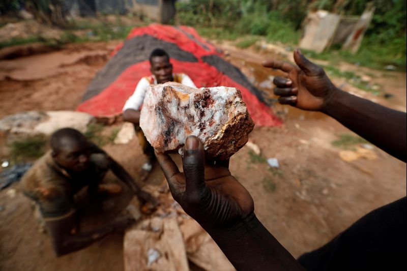 An informal gold miner holds up a rock recovered from inside a gold mine before it is ground down for processing at the site of Nsuaem-Top, Ghana, November 23, 2018. REUTERS/Zohra Bensemra