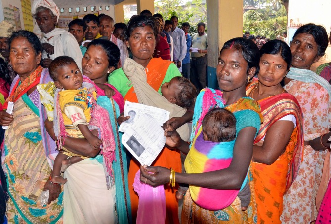 Lohardaga: Women in a queue to cast their votes at a polling station during the first phase of Jharkhand Assembly elections at Bhandra block in Lohardaga district, Saturday, Nov. 30, 2019. (PTI Photo)