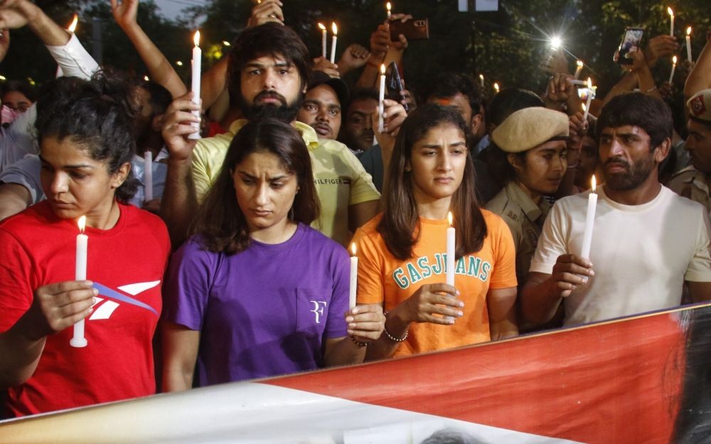 New Delhi: Wrestlers Bajrang Punia, Vinesh Phogat, Sangeeta Phogat, Sakshi Malik and others take out a Candle light march during their protest at Jantar Mantar, in New Delhi, Sunday, May 7, 2023. (Photo: Wasim Sarvar/IANS)