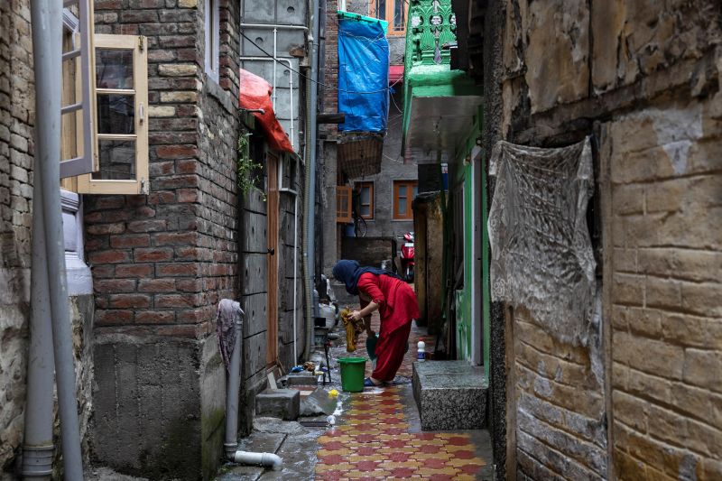 Kashmiri woman washes clothes in an alley during restrictions after the scrapping of the special constitutional status for Kashmir by the government, in Srinagar, August 14, 2019. (Photo by Danish Siddiqui/Reuters)