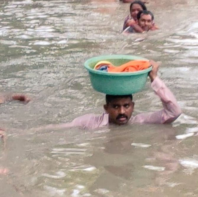 Vadodara cop carries baby in tub on his head in neck-deep water