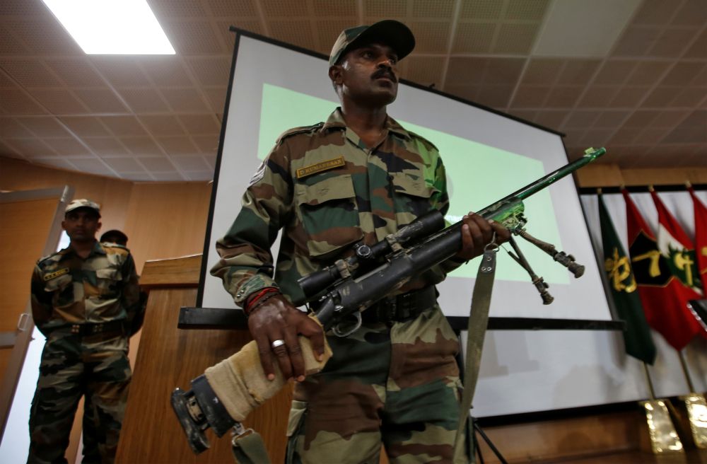 An Indian Army soldier displays a seized rifle during a news conference in Srinagar, August 2, 2019. REUTERS/Danish Ismail