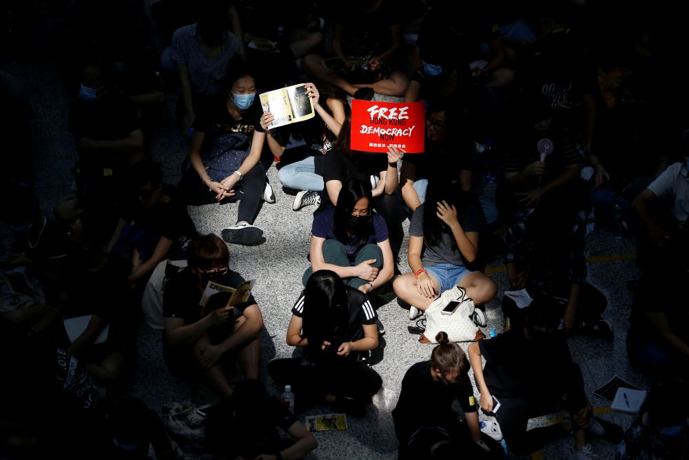 Anti-extradition bill demonstrators attend a protest at the arrival hall of Hong Kong Airport, China August 9, 2019.  REUTERS/Thomas Peter