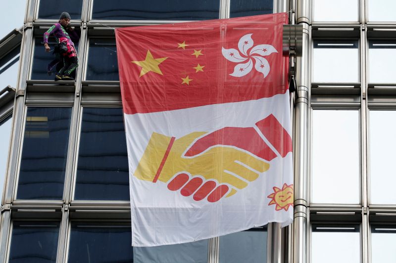 French 'spiderman' climbs HK tower, hoists reconciliation flag amid mass protests