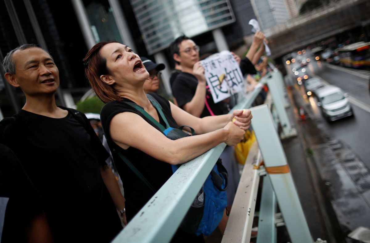 Hong Kong teachers rally in thunderstorm at start of weekend of protests