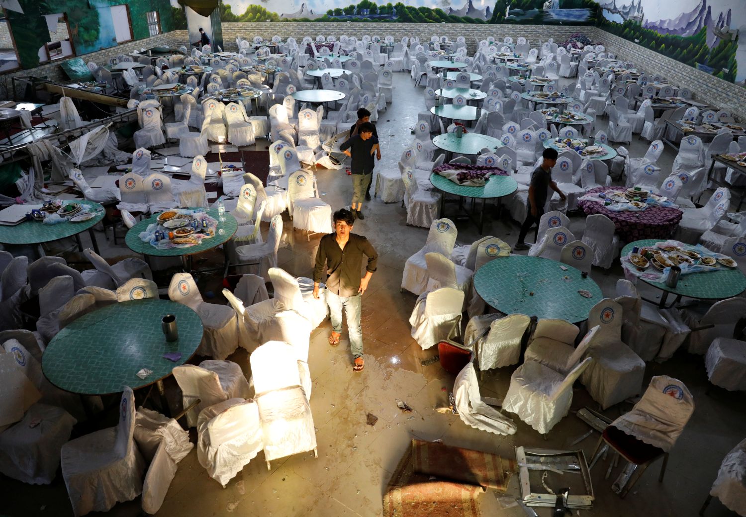 Workers inspect a damaged wedding hall after a blast in Kabul, Afghanistan August 18, 2019. REUTERS/Mohammad Ismail
