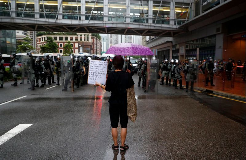 Hong Kong police briefly turn water cannon on protesters, fire tear gas