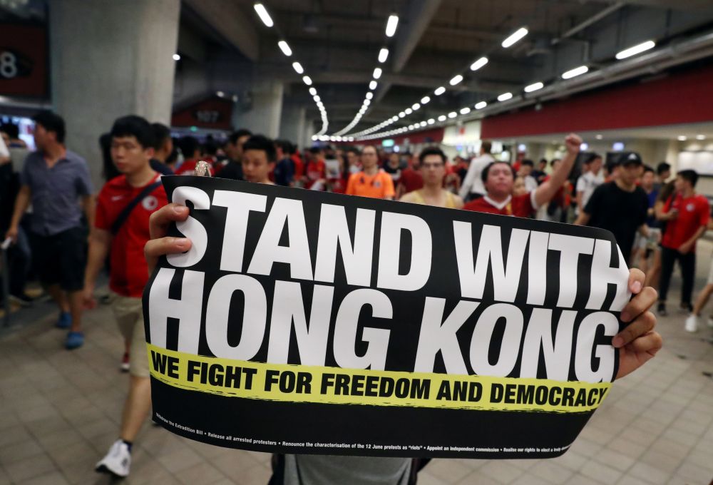 Hong Kong protesters boo Chinese anthem, as leader warns against interference