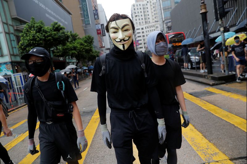 Petrol bombs and tear gas rock Hong Kong, scores arrested for defying mask ban
