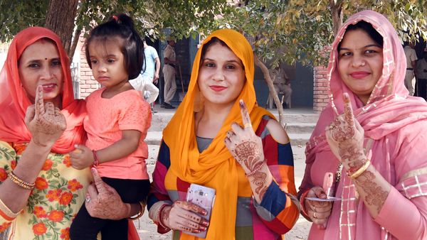 Female voters showing mark of indelible ink after casting their vote at a polling booth, during the Haryana Assembly Election in Gurgaon on Monday. (ANI)