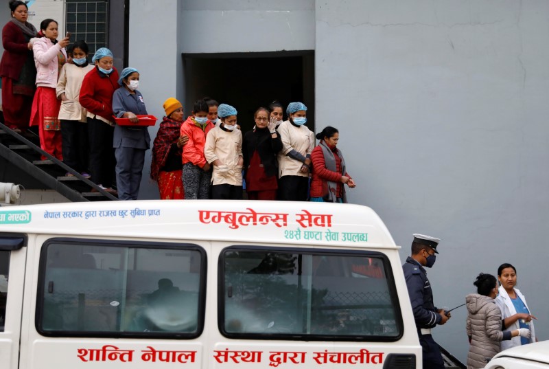Hospital staff observe as the bodies of eight Indian tourists who died due to suspected suffocation are carried inside an ambulance while being taken for postmortem in Kathmandu, Nepal January 21, 2020. REUTERS/Navesh Chitrakar
