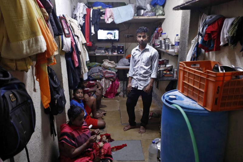 Ajay Kewat, a bank employee, poses for a photograph inside his house in Mumbai, India, March 23, 2020. Picture taken March 23, 2020. REUTERS/Francis Mascarenhas