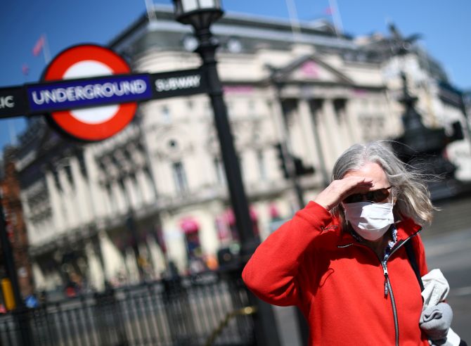 A woman is seen wearing a protective face mask, as the spread of the coronavirus disease (COVID-19) continues, London, Britain April 21, 2020.   REUTERS