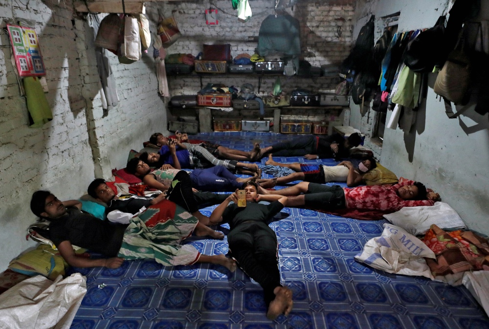 Migrant workers, who work in textile looms, rest inside a room after their looms were shut due to the 21-day nationwide lockdown to slow the spread of the coronavirus disease, in Bhiwandi on the outskirts of Mumbai, India, April 1, 2020. Picture taken Apr