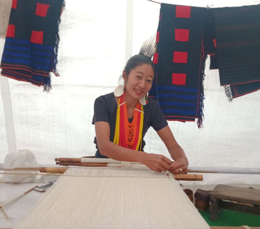 A damsel from Khiamniungan community demonstrates weaving