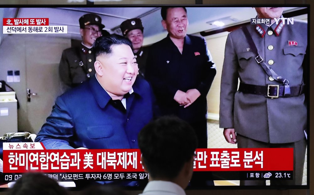 People watch a TV news program reporting North Korea's firing of projectiles with a file image of North Korean leader Kim Jong Un at the Seoul Railway Station in Seoul, South Korea, Saturday, Aug. 24, 2019. North Korea fired two suspected short-range ballistic missiles off its east coast on Saturday in the seventh consecutive week of weapons tests, South Korea’s military said, a day after it threatened to remain America’s biggest threat in protest of U.S.-led sanctions on the country. The Korean letters read: "North Korea fired projectiles." (AP Photo/Lee Jin-man)