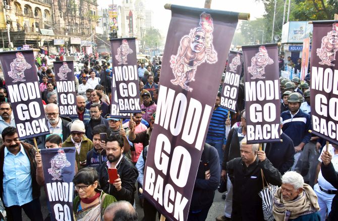 Demonstrators hold placards during a protest against Prime Minister Narendra Modi's visit in Kolkata. Photograph: ANI Photo