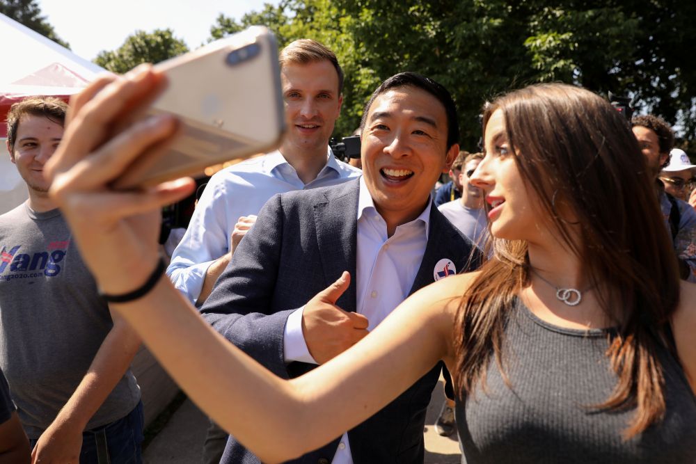 2020 Democratic U.S. presidential candidate Andrew Yang takes photos and answers questions from fairgoers at the Iowa State Fair in Des Moines, Iowa, U.S., August 9, 2019. REUTERS/Scott Morgan