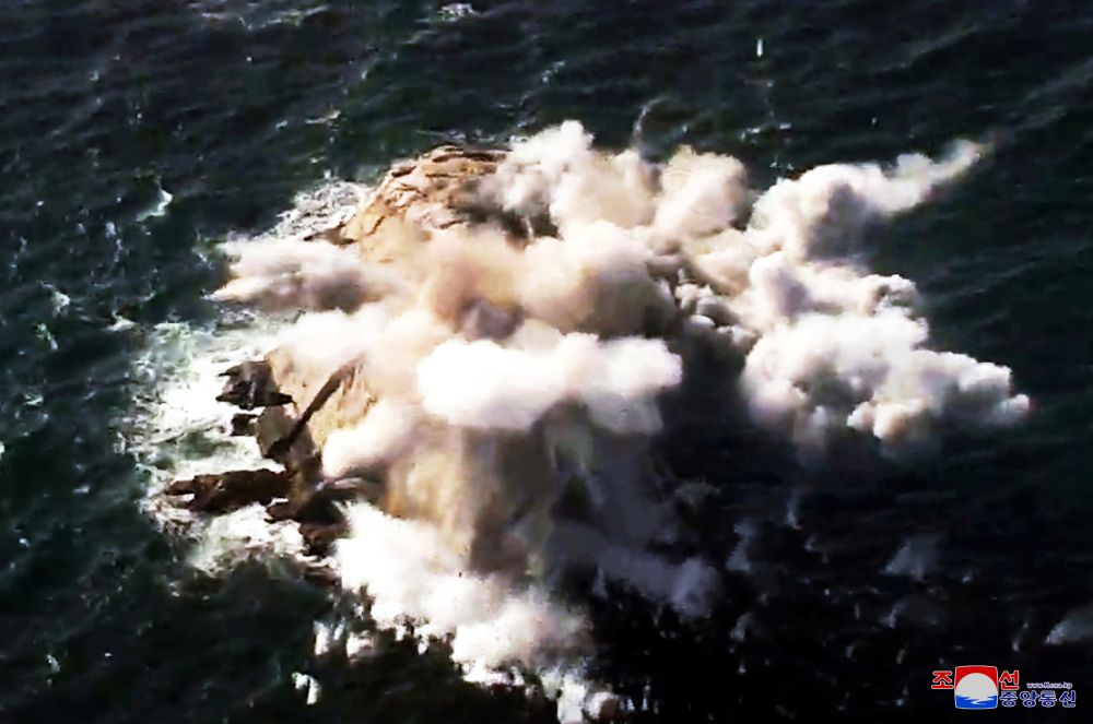 A missile breaks apart in the water as North Korean leader Kim Jong Un visits a drill of long-range artillery sub-units of the Korean People's Army, in North Korea in this image released by North Korea's Korean Central News Agency (KCNA) on March 2, 2020. KCNA via REUTERS