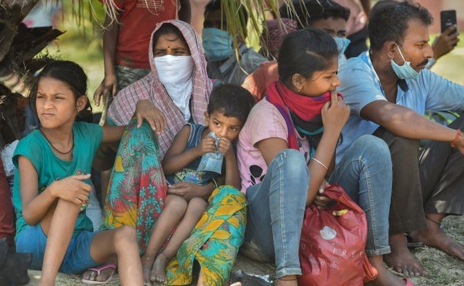 Migrant workers and their families await screening in Lucknow before being permitted to leave for their villages in Uttar Pradesh. Photograph: Nand Kumar/PTI Photo