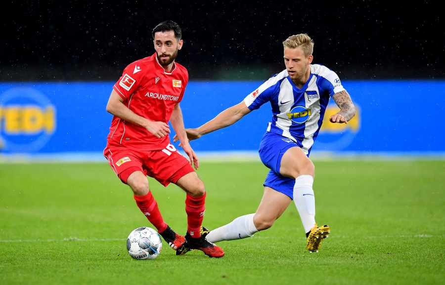 FC Union Berlin's Yunus Malli in action with Hertha BSC's Arne Maier, as play resumes behind closed doors following the outbreak of COVID-19. REUTERS