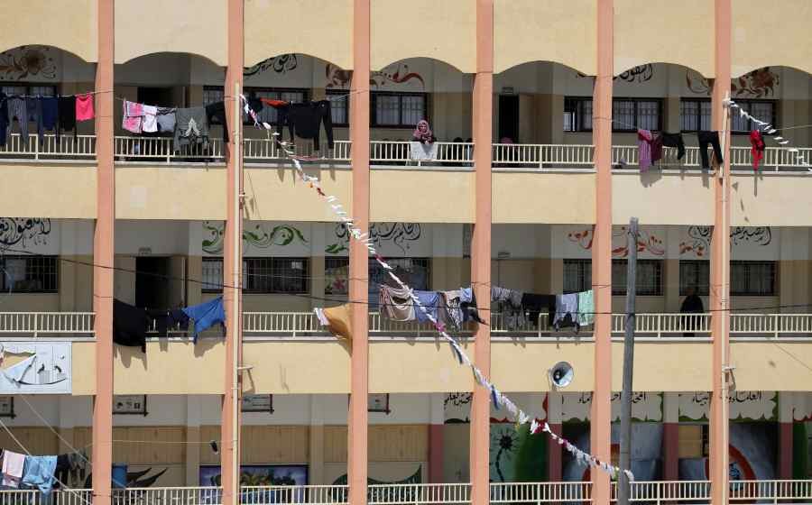 A Palestinian woman looks out from a school used as a quarantine facility amid concerns about the spread of the coronavirus disease (COVID-19), in the southern Gaza Strip. (REUTERS)