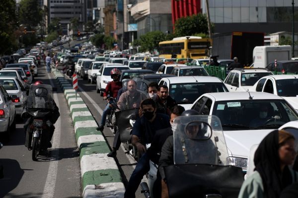 Iranians wear protective face masks, following the outbreak of the coronavirus disease (COVID-19), as they drive on their motorbikes in a crowded at street, in Tehran, Iran on May 20, 2020. (REUTERS Photo)