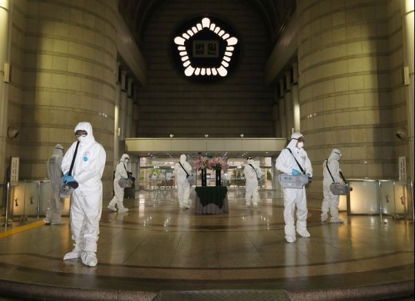 Quarantine workers spray disinfectant at the Seoul district court building, following the coronavirus disease (COVID-19) outbreak, in Seoul, South Korea on May 15, 2020. (REUTERS File Photo)
