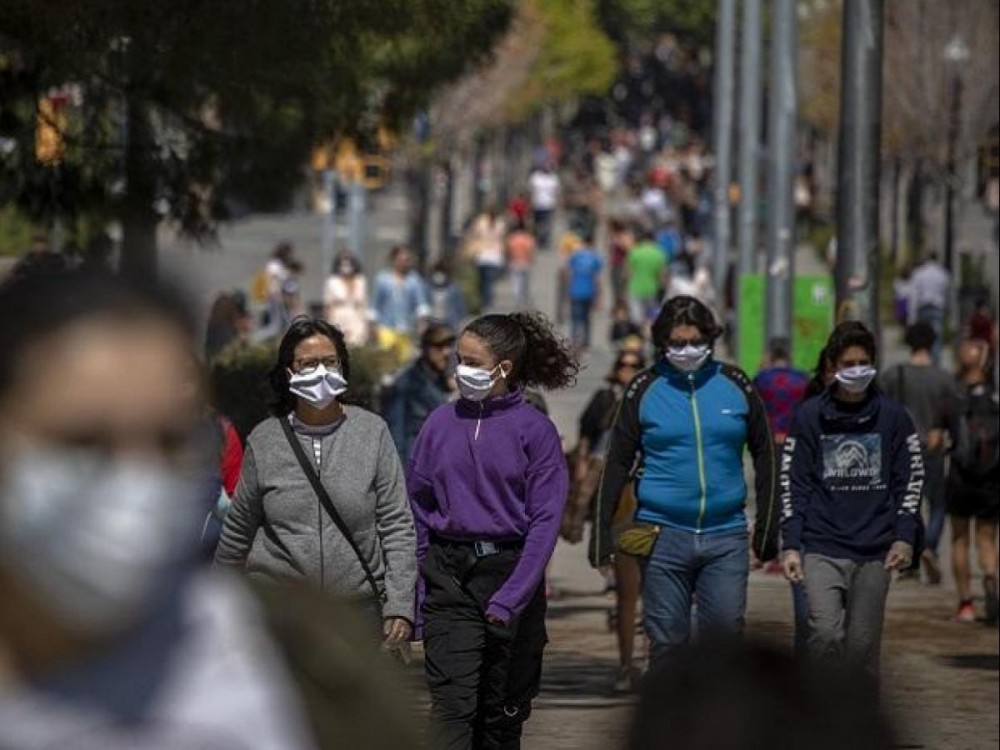 Families walk along a boulevard in Barcelona, Spain, as the lockdown to combat the spread of coronavirus continues. | Photo: AP/PTI