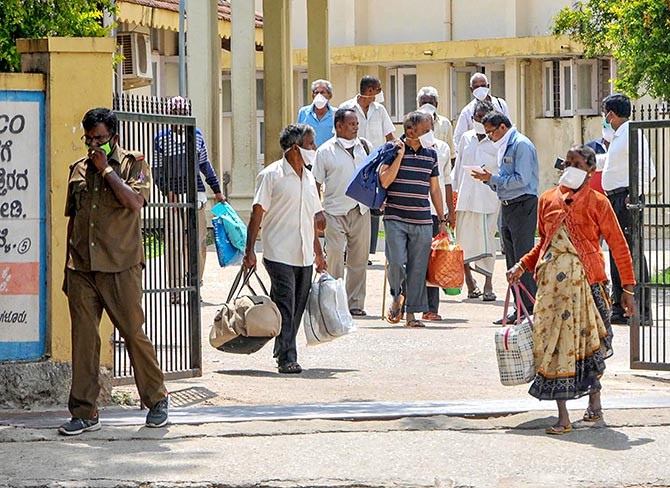 Patients who recovered from COVID-19 leave after being discharged from a hospital in Chikmagalur. Photograph: PTI Photo