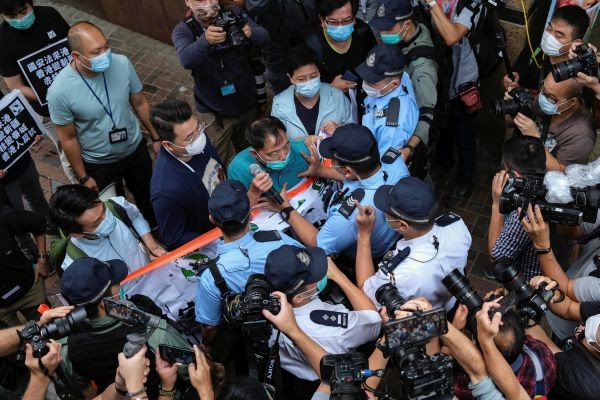 Pro-democracy lawmaker Wu Chi-wai scuffles with police during a march against new security laws, near China's Liaison Office, in Hong Kong, China May 22, 2020. (REUTERS Photo)