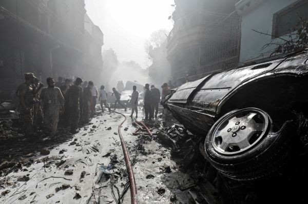 Rescue workers gather at the site of a passenger plane crash in a residential area near an airport in Karachi, Pakistan on May 22. (REUTERS Photo)
