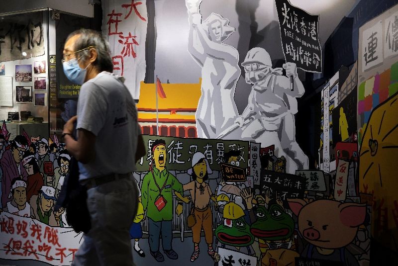 A man walks past an exhibition board during the opening of anti-extradition bill protest special exhibition at the June 4th Museum for the 1989 Tiananmen crackdown, in Hong Kong, China May 20, 2020. REUTERS/Tyrone Siu