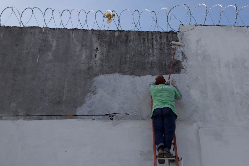 A man paints a wall of the Bangu Jail complex, Gericino, Rio De Janeiro, Brazil. (REUTERS File Photo)