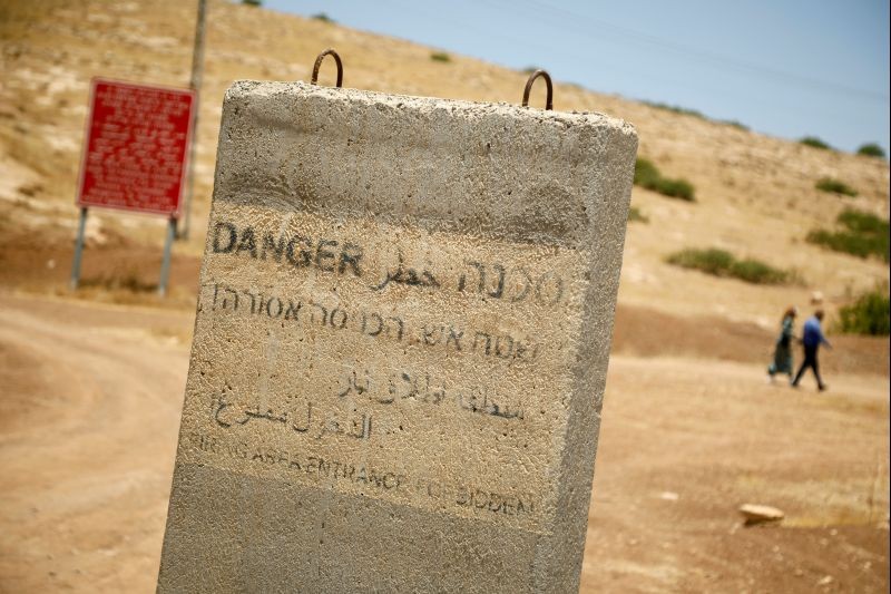 A concrete barrier with writings warning against entering into a firing area is seen in Jordan Valley in the Israeli-occupied West Bank on June 13, 2020. (REUTERS Photo)