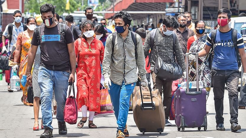 Passengers arrive at Howrah station to board a train, during the 4th phase of nationwide COVID-19 lockdown, in Kolkata on Saturday, 30 May. (Photo: PTI)