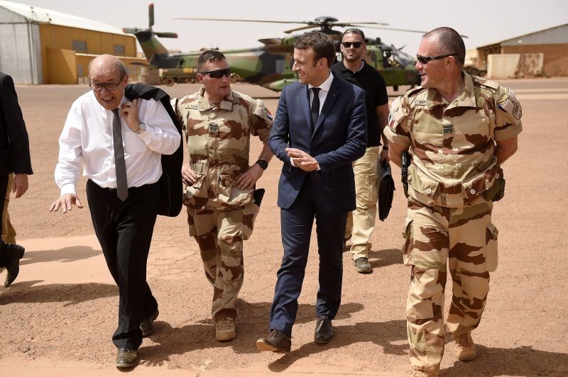 French President Emmanuel Macron (C) and French Foreign Affairs Minister Jean-Yves Le Drian (L) visit the troops of France's Barkhane operation in Africa's Sahel region in Gao, northern Mali on 19 May 2017. (REUTERS File Photo)