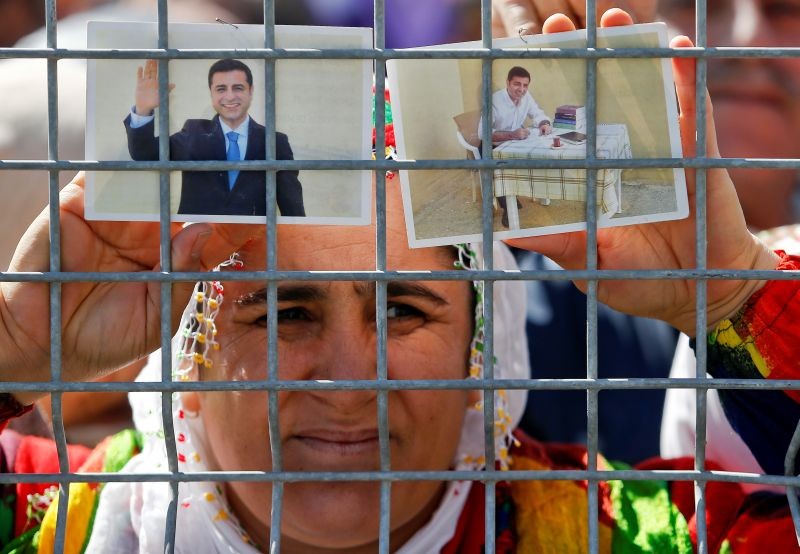 A woman holds pictures of jailed former leader of Turkey's main pro-Kurdish Peoples' Democratic Party Selahattin Demirtas as people gather to celebrate Newroz, which marks the arrival of spring and the new year, in Istanbul, Turkey on March 24, 2019. (REUTERS File photo)