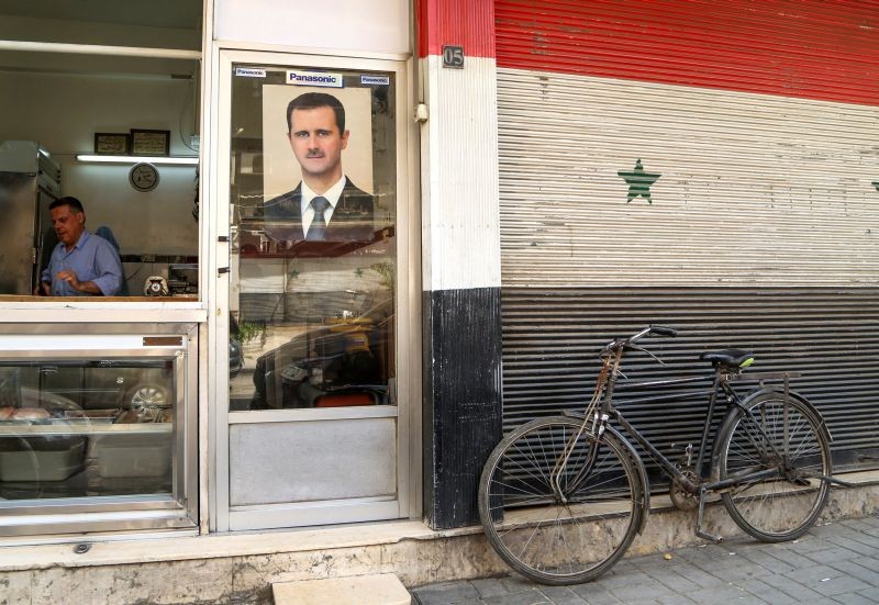 A picture of Syrian President Bashar al-Assad is seen on a door of a butcher shop, during a lockdown to prevent the spread of the coronavirus disease (COVID-19), in Damascus, Syria on April 22, 2020. (REUTERS File Photo)