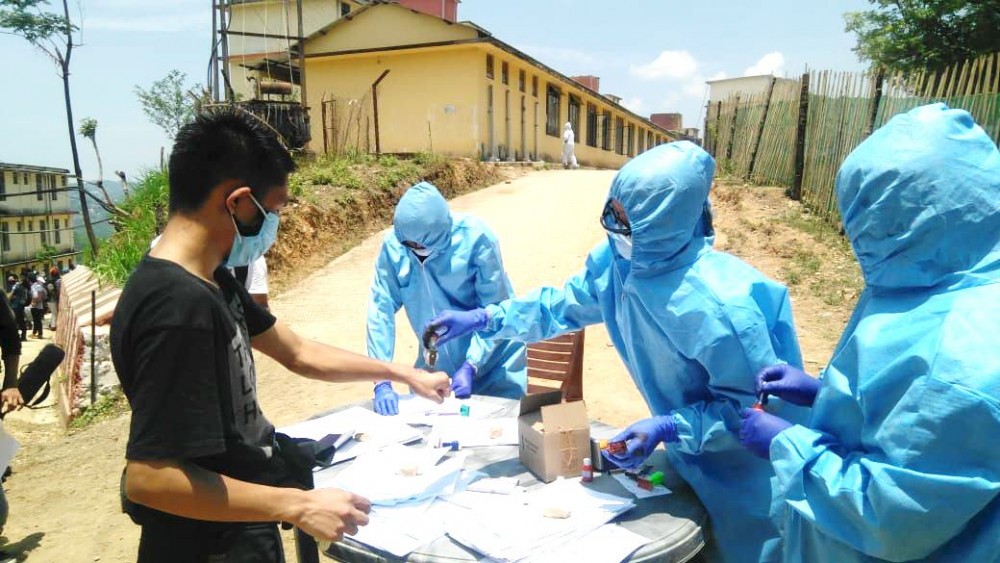 Frontline medical personnel registering returnees at the entrance of a quarantine centre in Kohima. (Morung Photo)