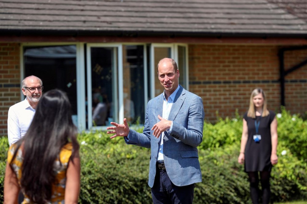 Britain's William, Duke of Cambridge, talks to staff at the Oxford Vaccine Group's facility at the Churchill Hospital during a visit to learn more about their work to establish a viable vaccine against the coronavirus disease (COVID-19), in Oxford, Britain, June 24, 2020. Steve Parsons/Pool via REUTERS