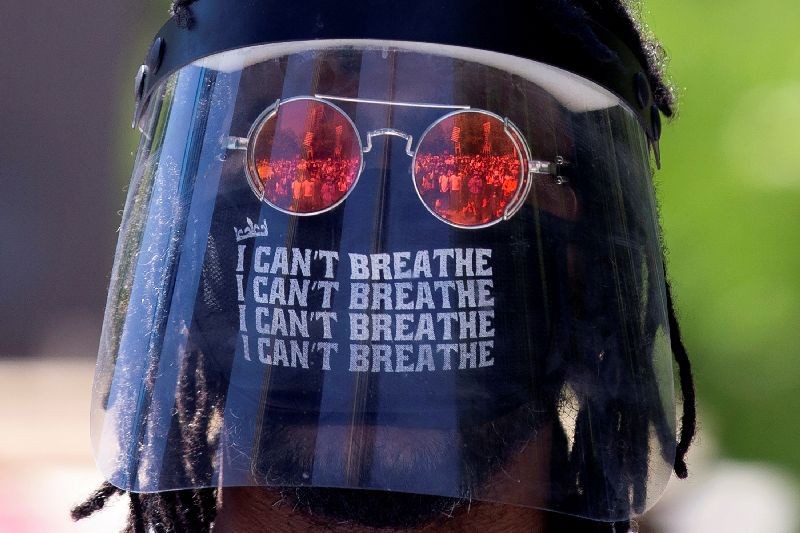 A man wears a face shield and mask during a protest against racial inequality and police brutality in the aftermath of the death in Minneapolis police custody of George Floyd, in Montreal, Quebec, Canada June 7, 2020.  REUTERS/Christinne Muschi