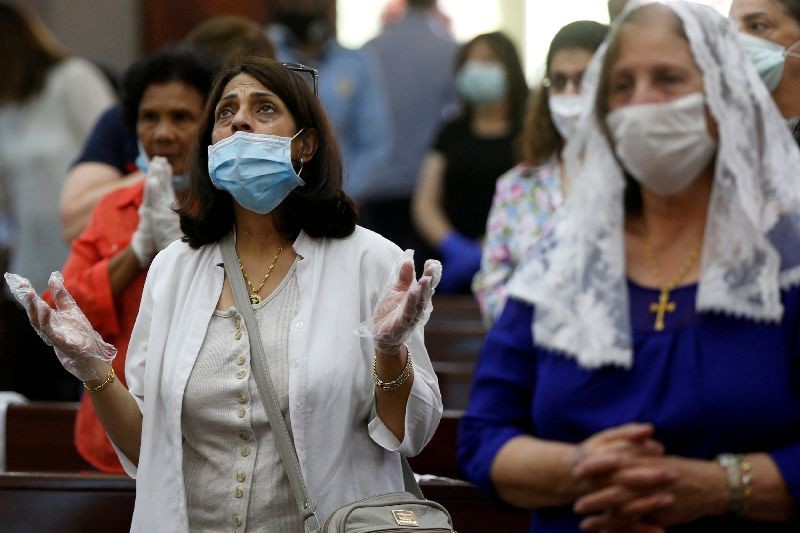 People wearing face masks attend a mass at the Church of Mary of Nazareth as places of worship reopen in Jordan after more than two months, amid concerns over the spread of the coronavirus disease (COVID-19), in downtown Amman, Jordan June 7, 2020. REUTERS/Muhammad Hamed