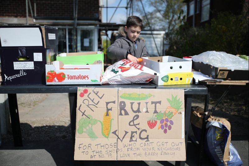 Joshua (9) prepares a free fruit and vegetable stall for elderly people as the spread of the coronavirus disease (COVID-19) continues, Bolton, Britain om April 17, 2020. (REUTERS File Photo)