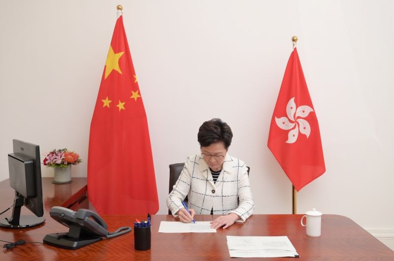 Hong Kong Chief Executive Carrie Lam signs the promulgation of the National Security Law in this picture released by the Hong Kong Information Services Department June 30, 2020. Hong Kong Information Services Department/Handout via REUTERS