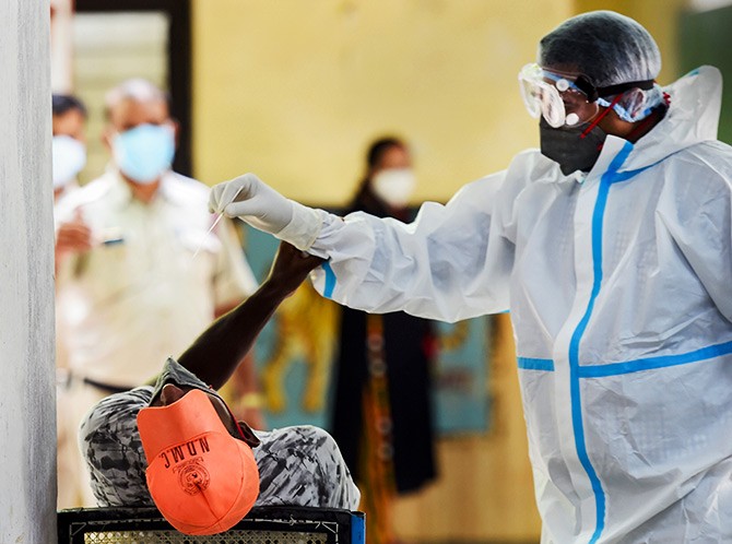 A medic collects samples for COVID-19 testing, in New Delhi. Photograph: Kamal Kishore/PTI Photo