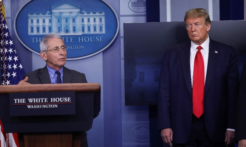 National Institute of Allergy and Infectious Diseases director Dr. Anthony Fauci speaks as U.S. President Donald Trump listens during the daily coronavirus task force briefing at the White House in Washington, U.S., April 13, 2020. REUTERS/Leah Millis/File Photo