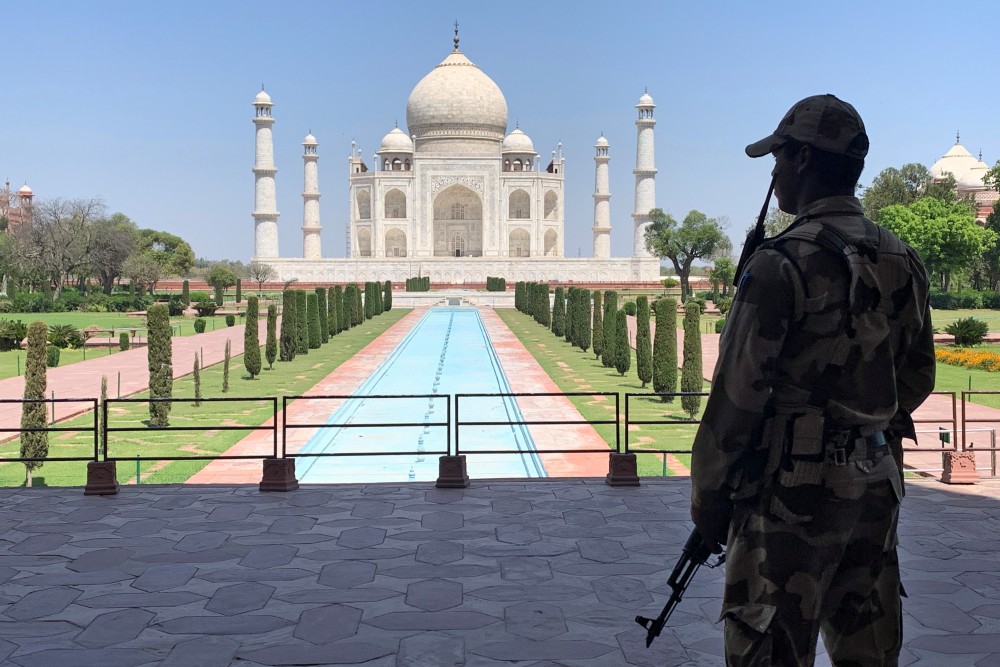 A Central Industrial Security Force (CISF) personnel stands guard inside the empty premises of the historic Taj Mahal during a 21-day nationwide lockdown to slow the spreading of the coronavirus disease (COVID-19), in Agra, India, April 2, 2020. REUTERS/Sunil Kataria/Files