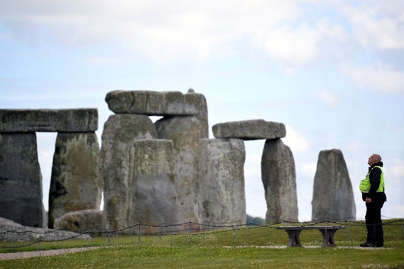 A security officer patrols around the perimeter Stonehenge stone circle, where official Summer Solstice celebrations were cancelled due to the spread of the coronavirus disease (COVID-19), near Amesbury, Britain June 20, 2020. REUTERS/Toby Melville/File Photo